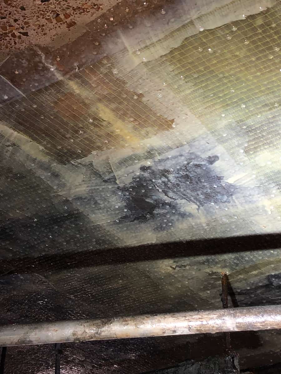 Slab underside covered with a translucent mesh-textured glass fiber wrap.