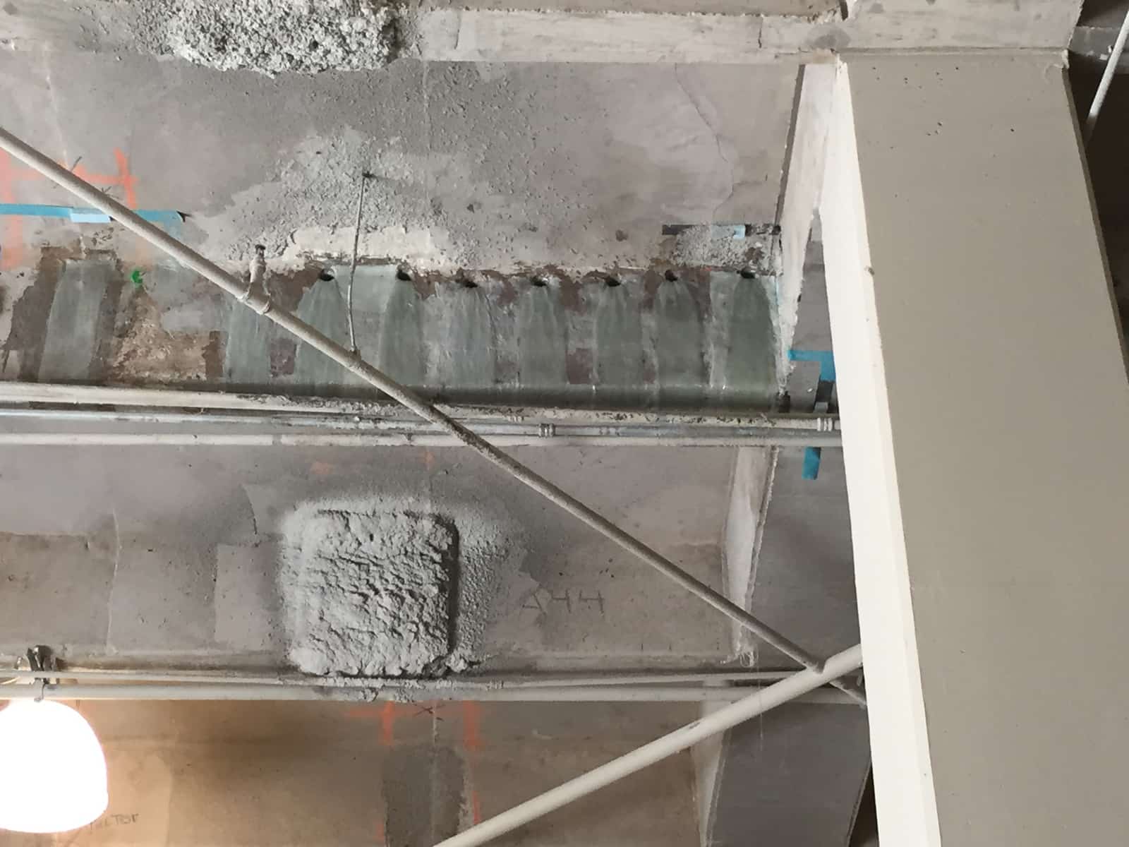 Concrete beam with composite wrap and fan anchors near a column.