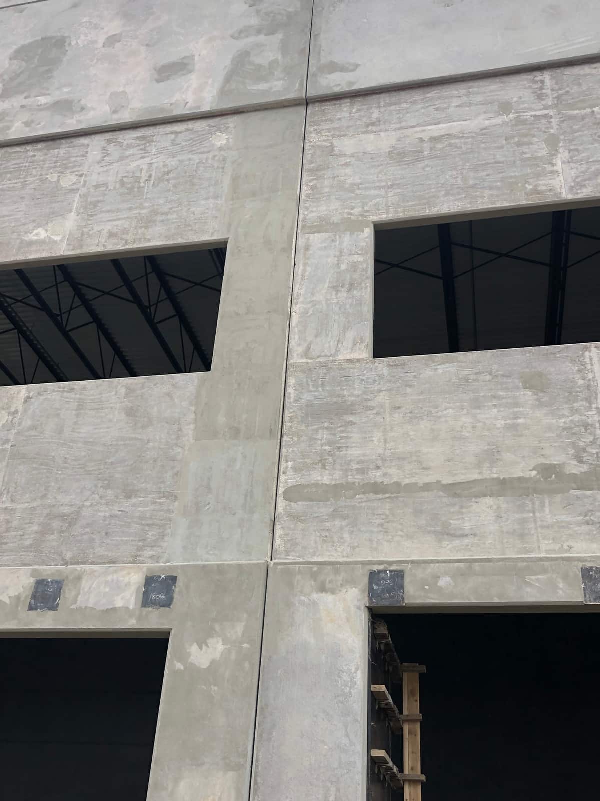 Concrete tilt-up wall panels with window openings.