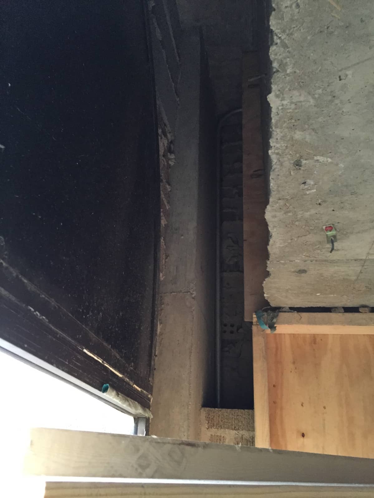 Concrete column and beam with visible cracking before FRP strengthening.