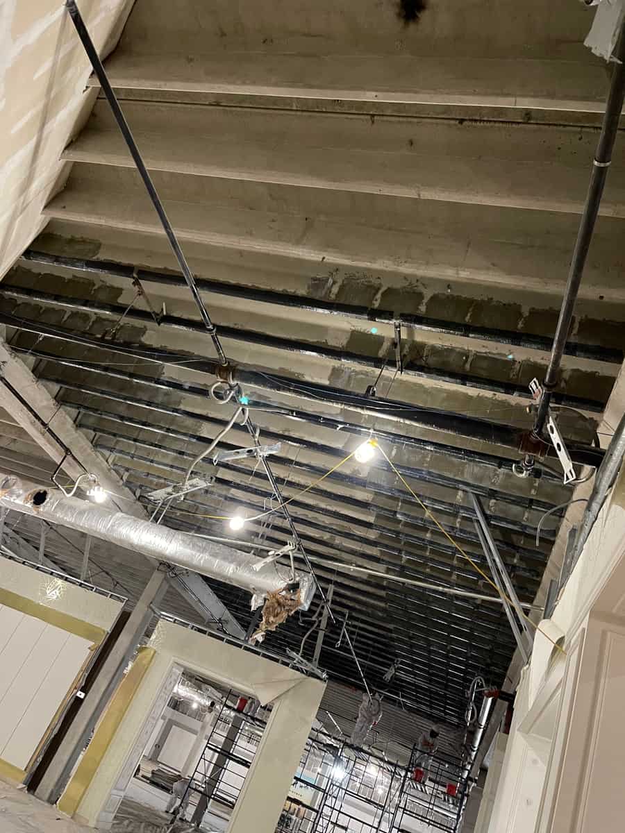 Joist ceiling with carbon fiber strips above ductwork.