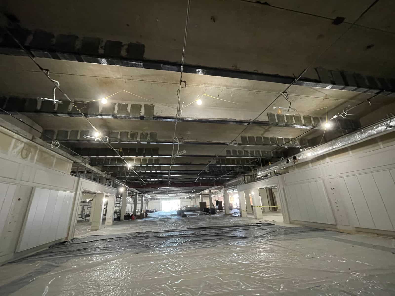 Wide view of a joist ceiling with carbon fiber strips along the girder lines.